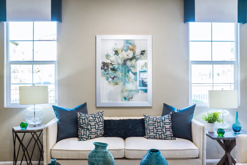 tulsa upholstery white sofa in living room with blue throw pillows